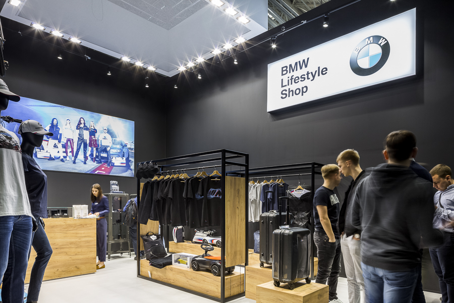 Realizacja zabudowy dla wiodących marek motoryzacyjnych podczas Poznań Motor Show to monumentalny projekt o łącznej powierzchni przekraczającej 4500 m². Jako BWS EXPO zapewniliśmy kompleksowe wsparcie techniczne i wykonawcze, tworząc spójne, a jednocześnie unikalne przestrzenie ekspozycyjne dla marek takich jak BMW, Porsche, Audi, Rolls-Royce oraz całej grupy Volkswagen (Skoda, Seat, VW). Kluczowe aspekty techniczno-wykonawcze: Skala i Logistyka: Równoczesna budowa stoisk dla wielu marek premium wymagała perfekcyjnej koordynacji prac montażowych oraz logistyki materiałowej w kilku halach targowych. Design i Materiały: Każda przestrzeń została wykończona zgodnie z rygorystycznymi standardami wizualnymi (Corporate Identity) poszczególnych brandów. Wykorzystano m.in. eleganckie okładziny drewniane dla stref luksusowych (Rolls-Royce, Porsche), nowoczesne konstrukcje loftowe oraz wysokiej jakości posadzki targowe. Systemy Podwieszeń i Multimeadia: Zastosowano zaawansowane konstrukcje kratownicowe z wielkoformatowymi ekranami LED, dynamicznym oświetleniem scenicznym oraz potężnymi elementami brandingowymi (np. charakterystyczne ringi Volkswagen Financial Services czy kubiki BMW), które zapewniały widoczność marek z dużej odległości. Strefy Specjalne: Realizacja objęła budowę dwupoziomowych stref VIP, butików Lifestyle Shop (BMW), profesjonalnych recepcji z grafikami oraz interaktywnych stoisk usług finansowych. Dzięki doświadczeniu w obsłudze największych wydarzeń motoryzacyjnych, dostarczyliśmy infrastrukturę, która połączyła technologiczną nowoczesność z prestiżem, tworząc idealne tło dla premier motoryzacyjnych najwyższej klasy.